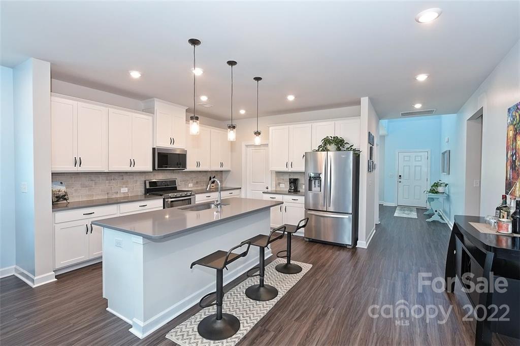 3838 Isenhour Road Kannapolis, NC 28081 - Photo 7 of 17 a kitchen with a sink a counter top stainless steel appliances and cabinets