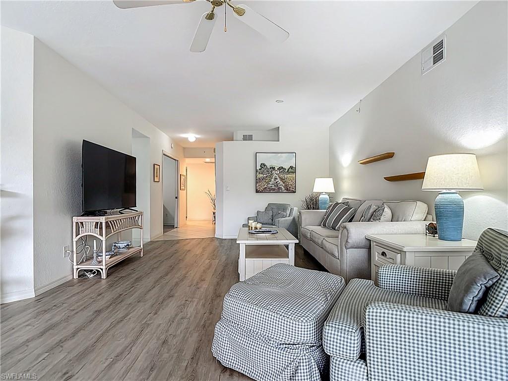 6834 Lantana Bridge Road, Unit 102 Naples, FL 34109 - Photo 12 of 45 a living room with furniture and a flat screen tv