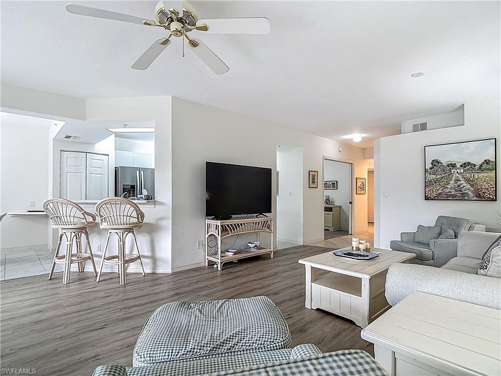 6834 Lantana Bridge Road, Unit 102 Naples, FL 34109 - Photo 13 of 45 a living room with furniture and a flat screen tv