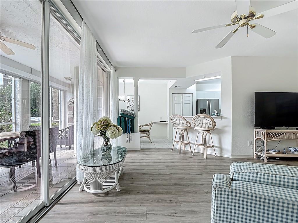 6834 Lantana Bridge Road, Unit 102 Naples, FL 34109 - Photo 14 of 45 a living room with furniture and a flat screen tv