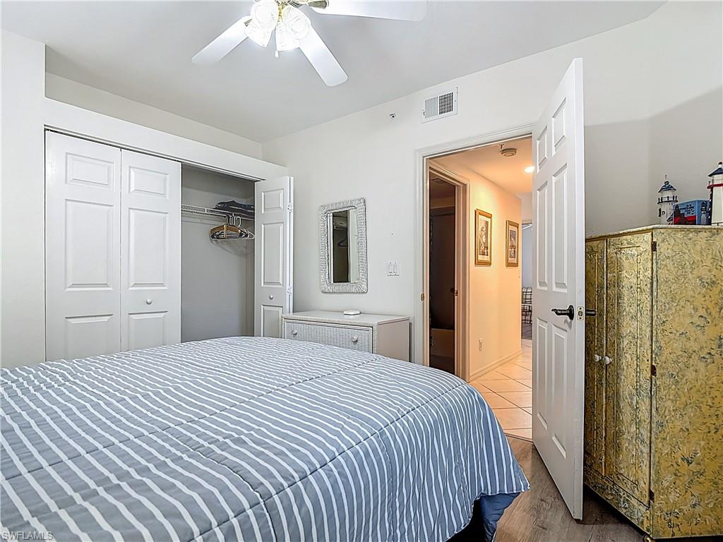 6834 Lantana Bridge Road, Unit 102 Naples, FL 34109 - Photo 22 of 45 a bedroom with a bed and a mirror