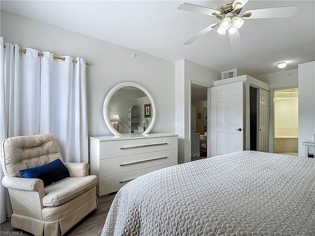 6834 Lantana Bridge Road, Unit 102 Naples, FL 34109 - Photo 28 of 45 a bedroom with a bed and a couch