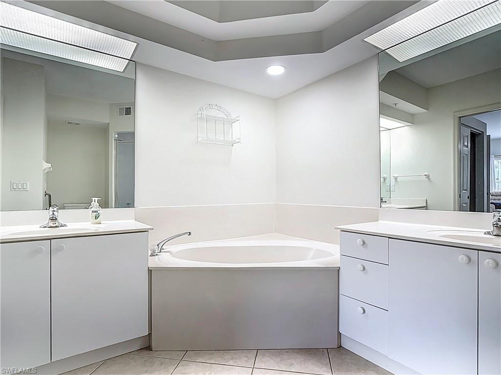 6834 Lantana Bridge Road, Unit 102 Naples, FL 34109 - Photo 31 of 45 a bathroom with a sink and a mirror