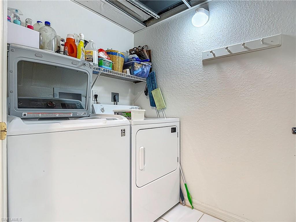 6834 Lantana Bridge Road, Unit 102 Naples, FL 34109 - Photo 35 of 45 a utility room with dryer and washer