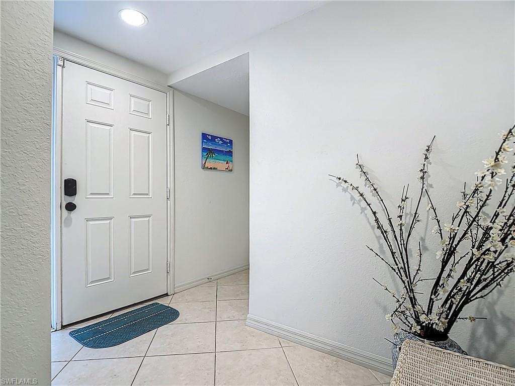 6834 Lantana Bridge Road, Unit 102 Naples, FL 34109 - Photo 4 of 45 a view of a livingroom with a and white wall