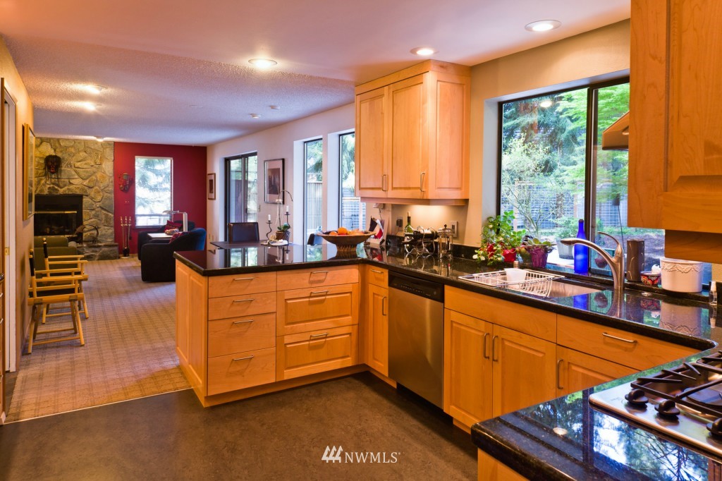 621 Canyon View Road Bellingham, WA 98225 - Photo 5 of 15 a kitchen with stainless steel appliances kitchen island granite countertop a stove a sink dishwasher and cabinets with wooden floor