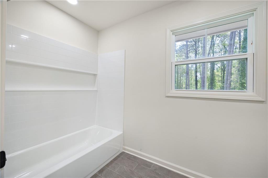 4289 Kimball Road Southwest Atlanta, GA 30331 - Photo 19 of 20 a bathroom with a bathtub and window