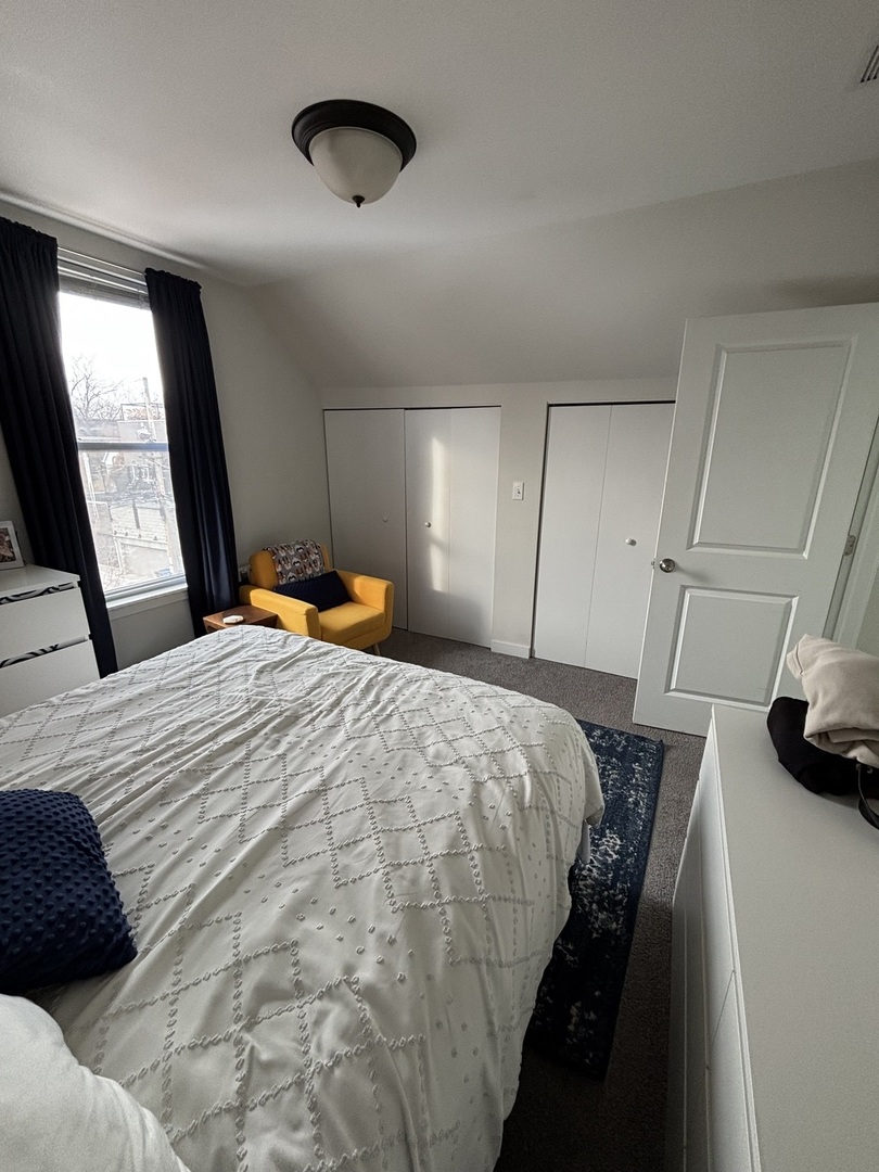 1644 North Hermitage Avenue, Unit 2R Chicago, IL 60622 - Photo 13 of 18 a bedroom with a bed and window