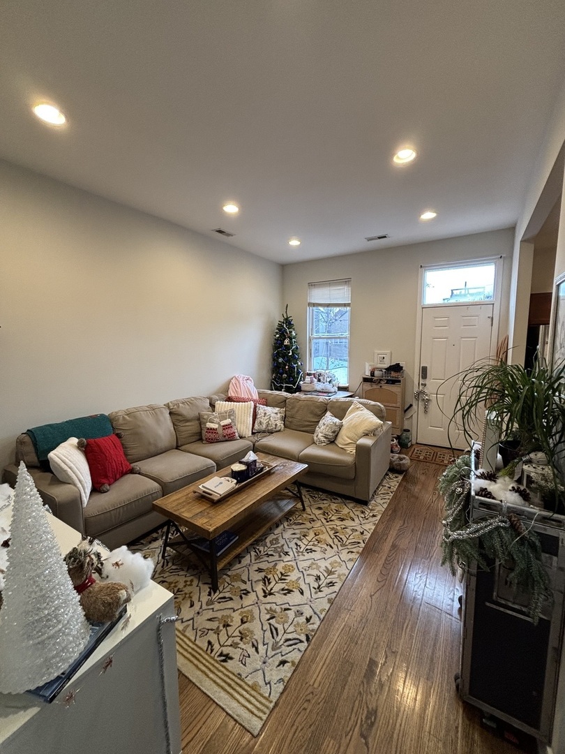 1644 North Hermitage Avenue, Unit 2R Chicago, IL 60622 - Photo 2 of 18 a living room with furniture hard wood floor and a table