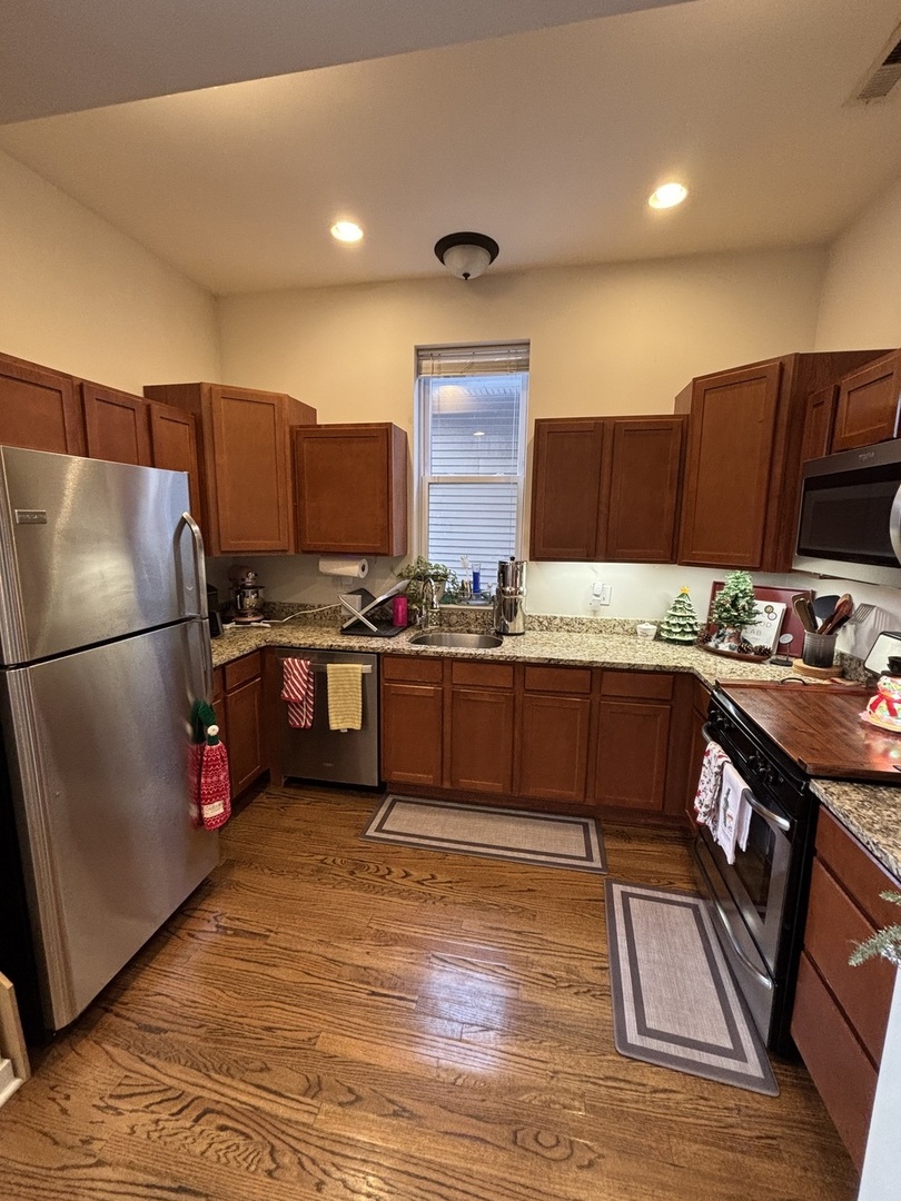 1644 North Hermitage Avenue, Unit 2R Chicago, IL 60622 - Photo 5 of 18 a kitchen with stainless steel appliances granite countertop a refrigerator and a stove top oven