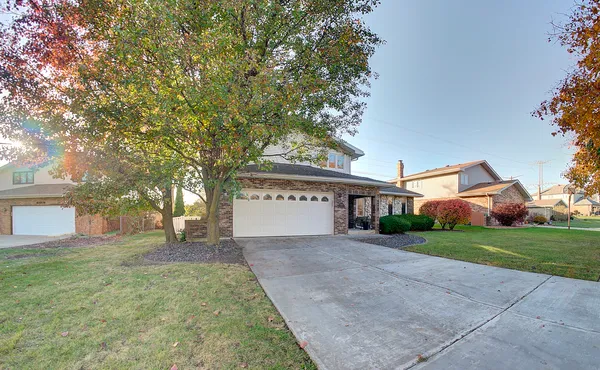 a view of a house with a yard and garage