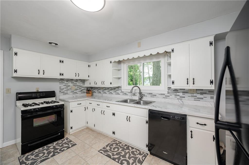 3263 Hubbard-Middlesex Road West Middlesex, PA 16159 - Photo 4 of 21 a kitchen with granite countertop a sink stove and cabinets