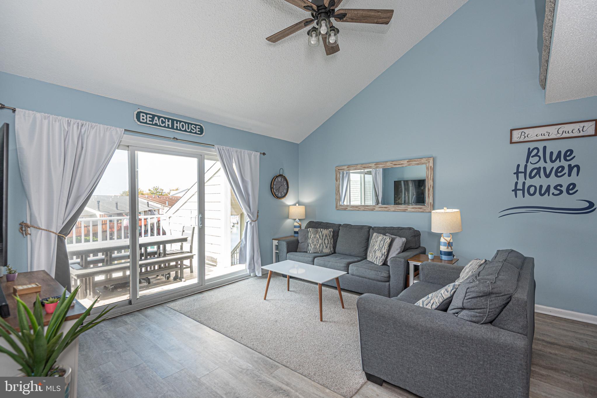 9203 Rusty Anchor Road, Unit A5 Ocean City, MD 21842 - Photo 12 of 60 a living room with furniture and a large window