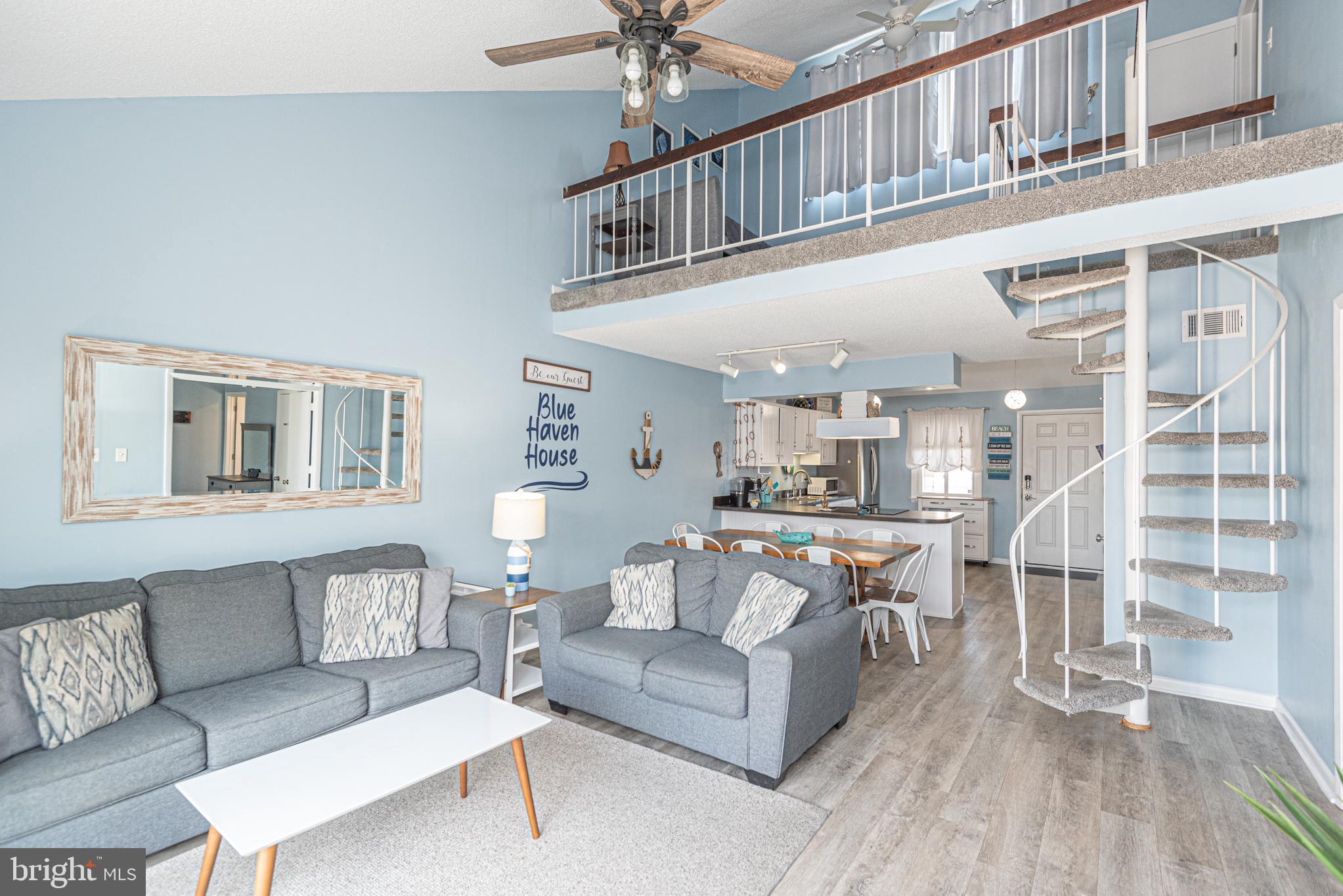 9203 Rusty Anchor Road, Unit A5 Ocean City, MD 21842 - Photo 15 of 60 a living room with furniture and a fireplace