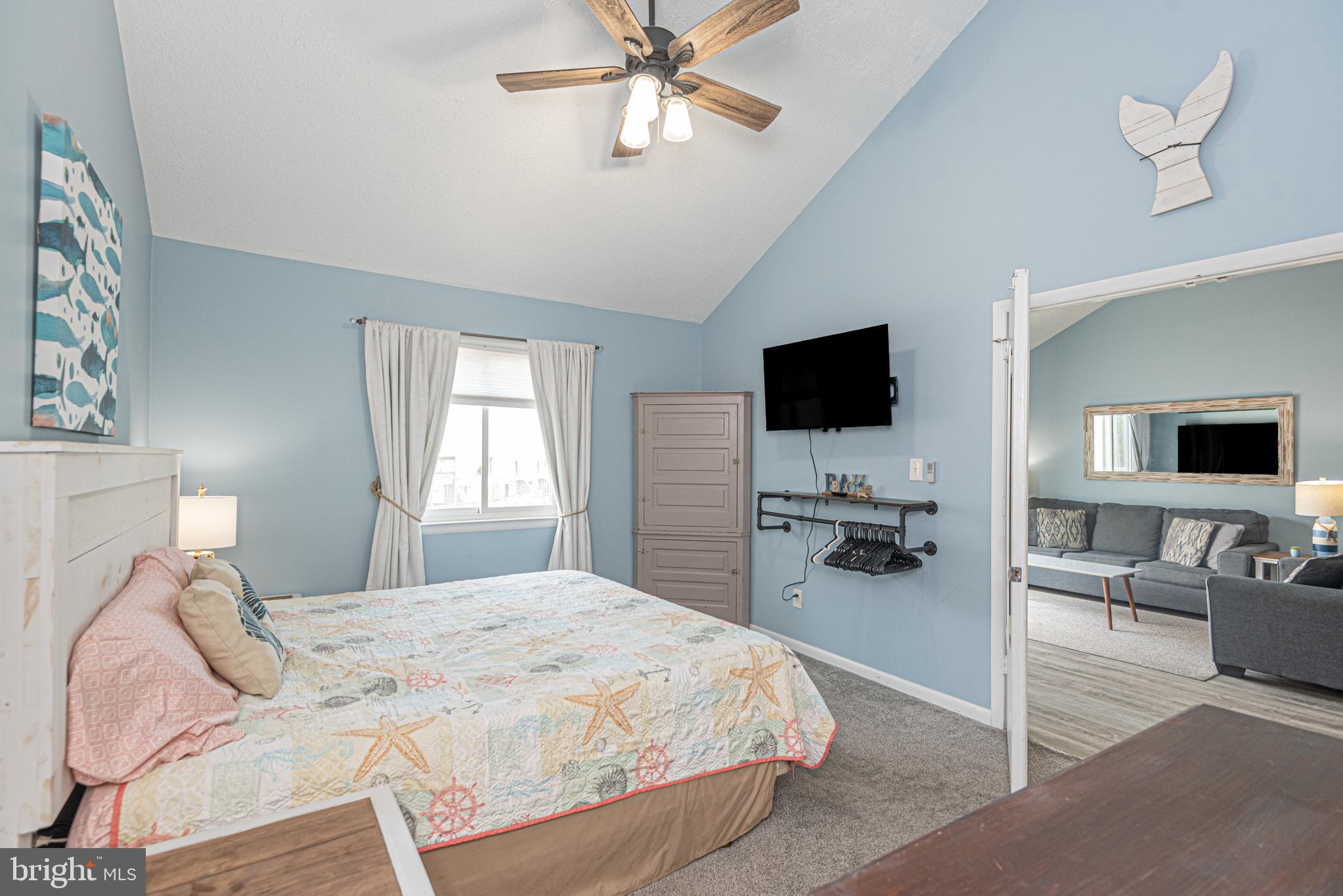 9203 Rusty Anchor Road, Unit A5 Ocean City, MD 21842 - Photo 25 of 60 a bedroom with a bed and tv