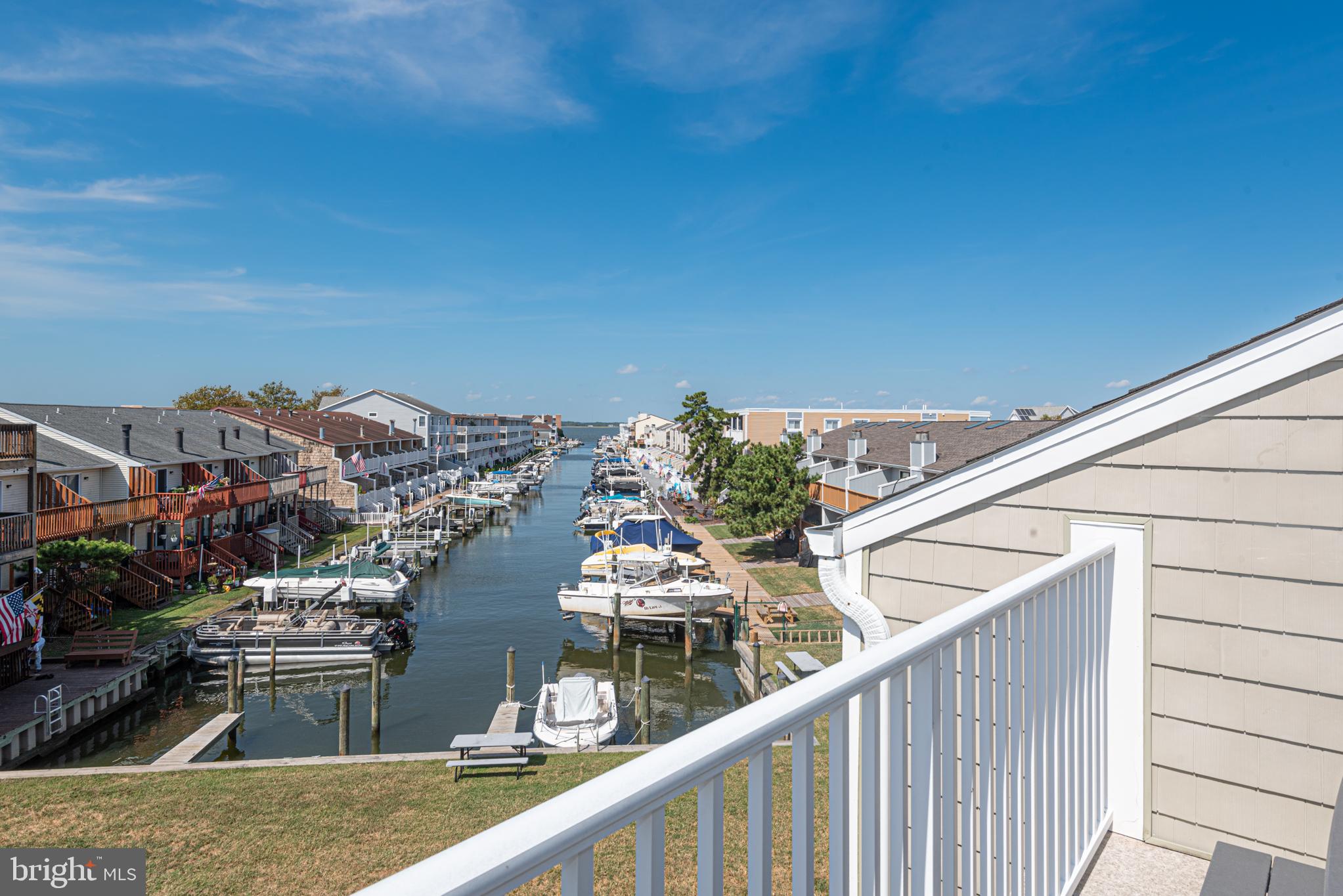 9203 Rusty Anchor Road, Unit A5 Ocean City, MD 21842 - Photo 28 of 60 a view of a balcony with wooden floor and fence
