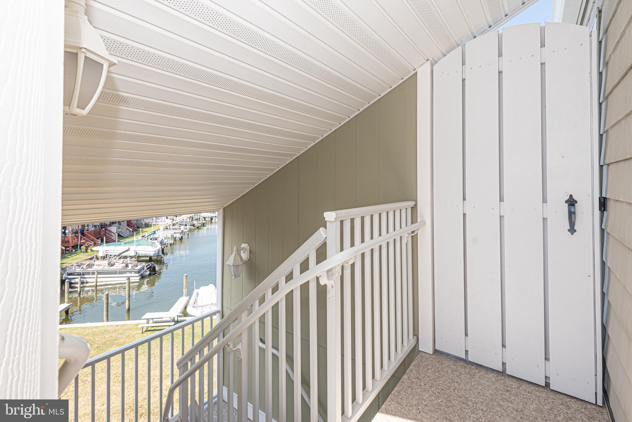 9203 Rusty Anchor Road, Unit A5 Ocean City, MD 21842 - Photo 30 of 60 a view of a hallway with white walls and stairs