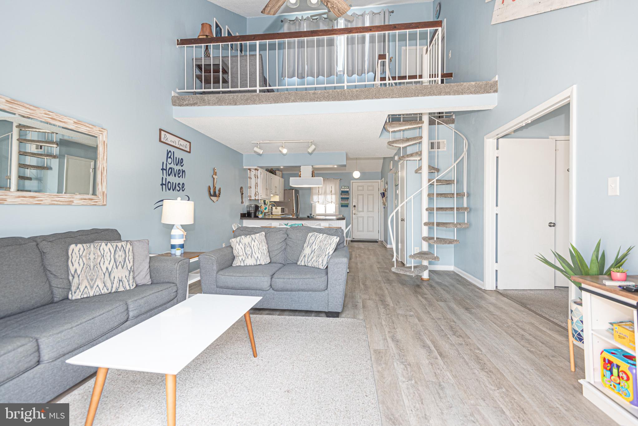 9203 Rusty Anchor Road, Unit A5 Ocean City, MD 21842 - Photo 32 of 60 a living room with furniture and a wooden floor