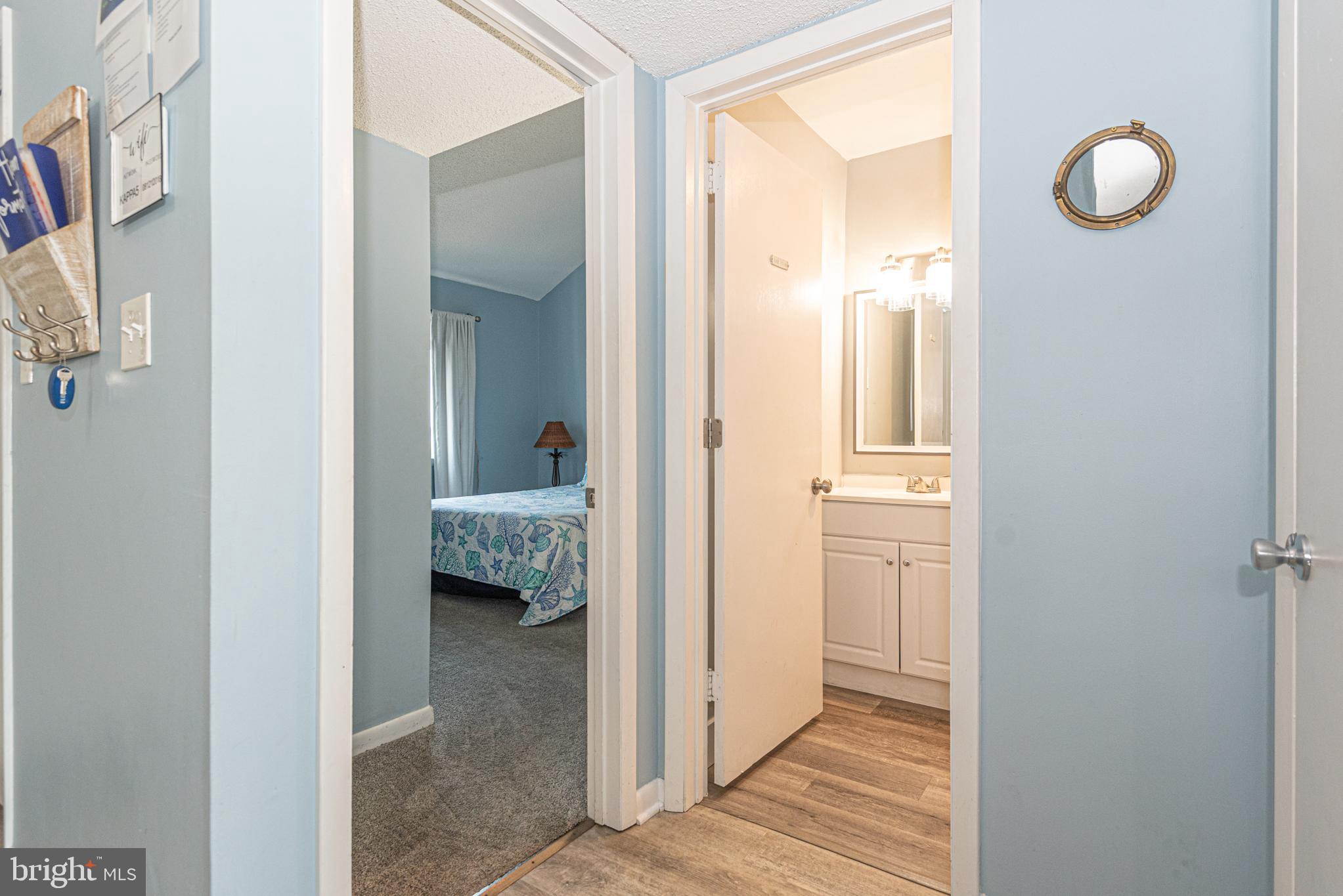 9203 Rusty Anchor Road, Unit A5 Ocean City, MD 21842 - Photo 34 of 60 a view of a hallway with bathroom and mirror