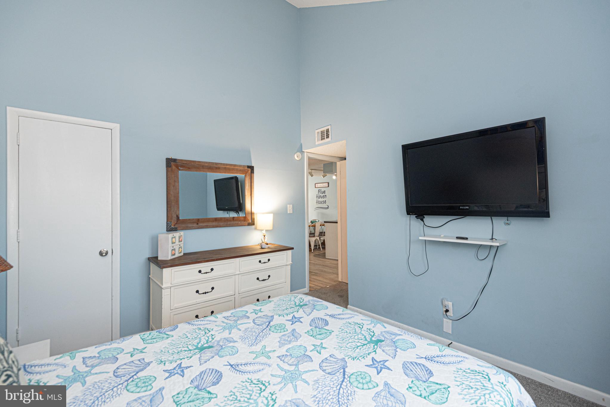 9203 Rusty Anchor Road, Unit A5 Ocean City, MD 21842 - Photo 37 of 60 a bedroom with a bed and a flat screen tv