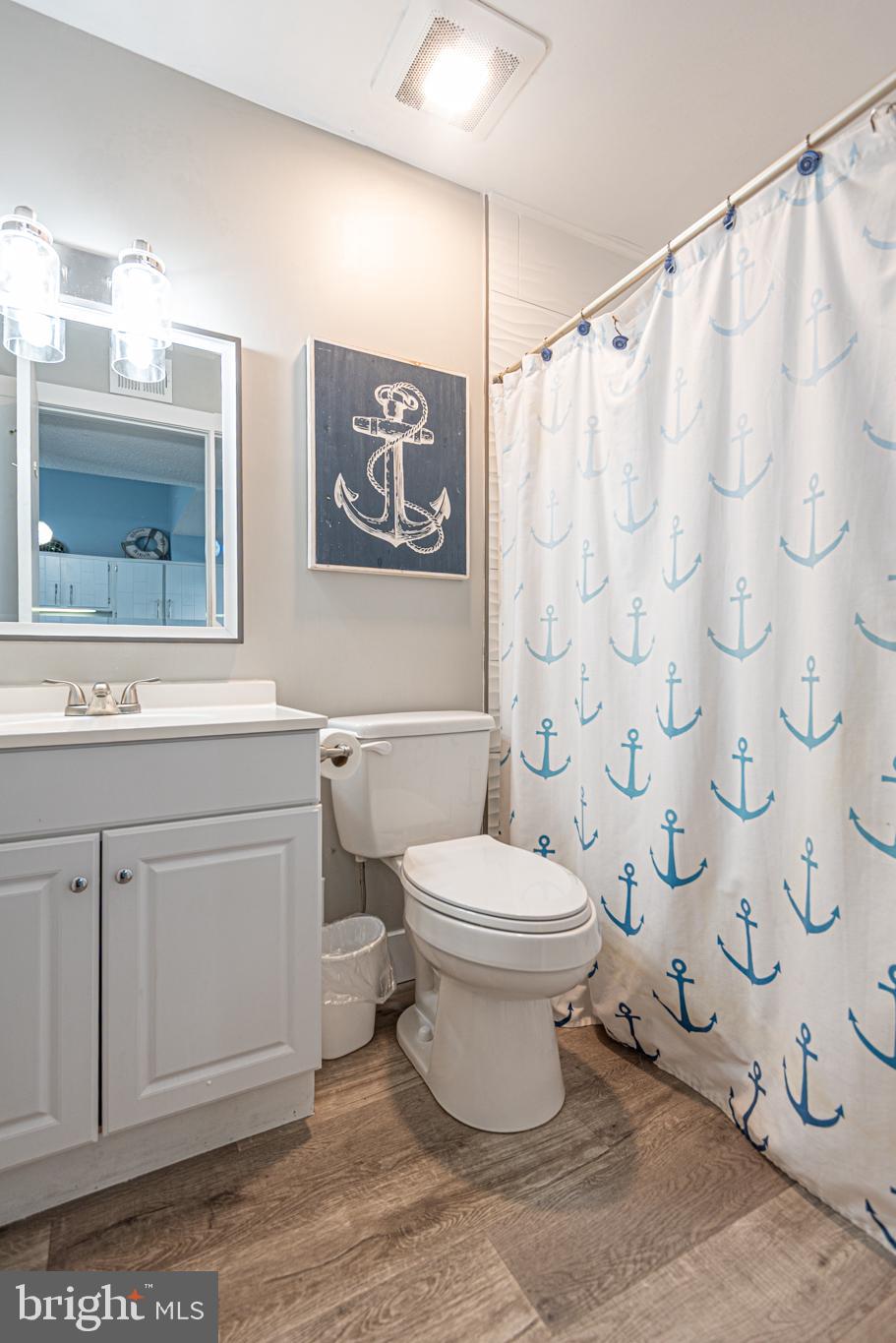 9203 Rusty Anchor Road, Unit A5 Ocean City, MD 21842 - Photo 39 of 60 a bathroom with a toilet sink and a mirror