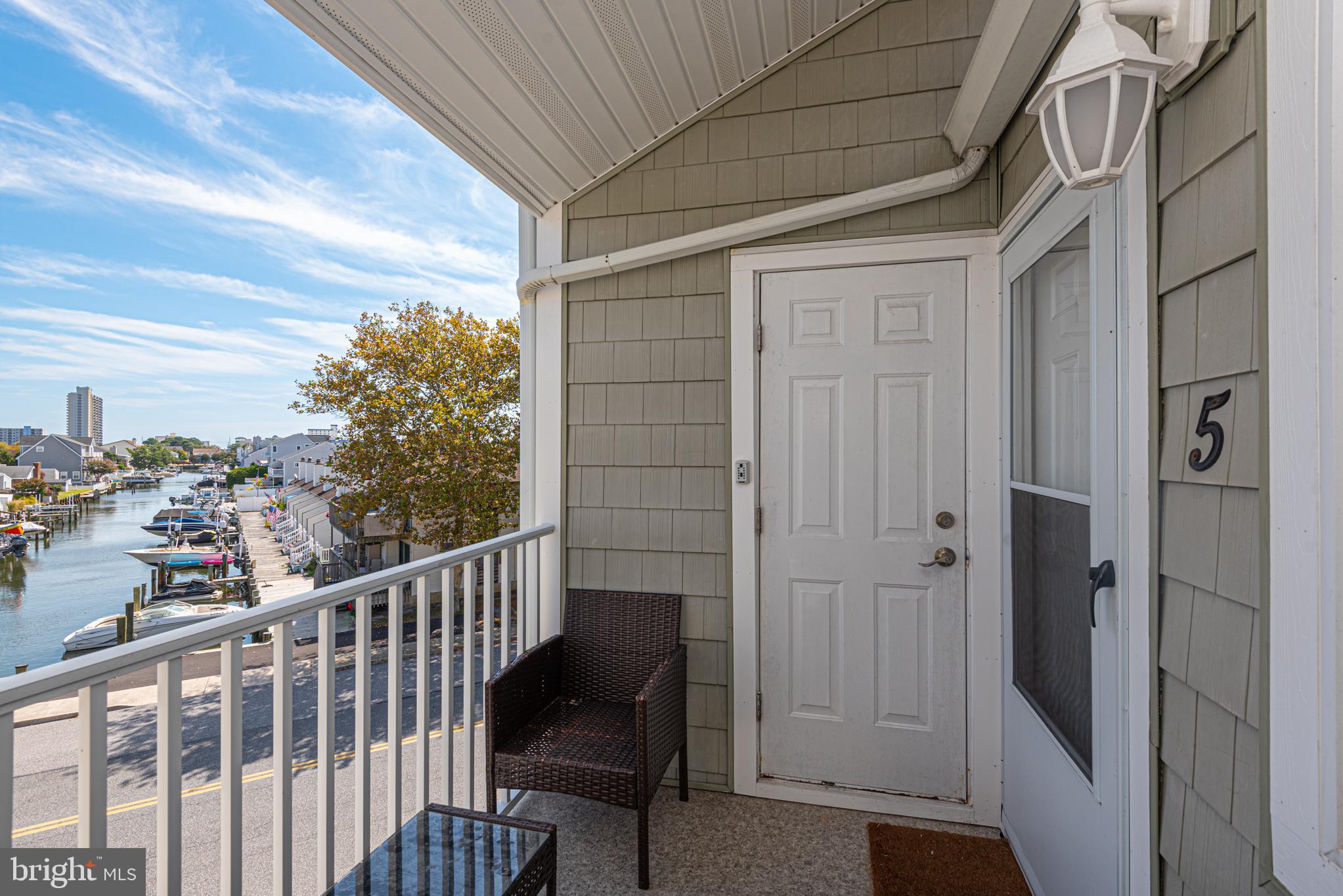 9203 Rusty Anchor Road, Unit A5 Ocean City, MD 21842 - Photo 4 of 60 a view of a balcony with furniture