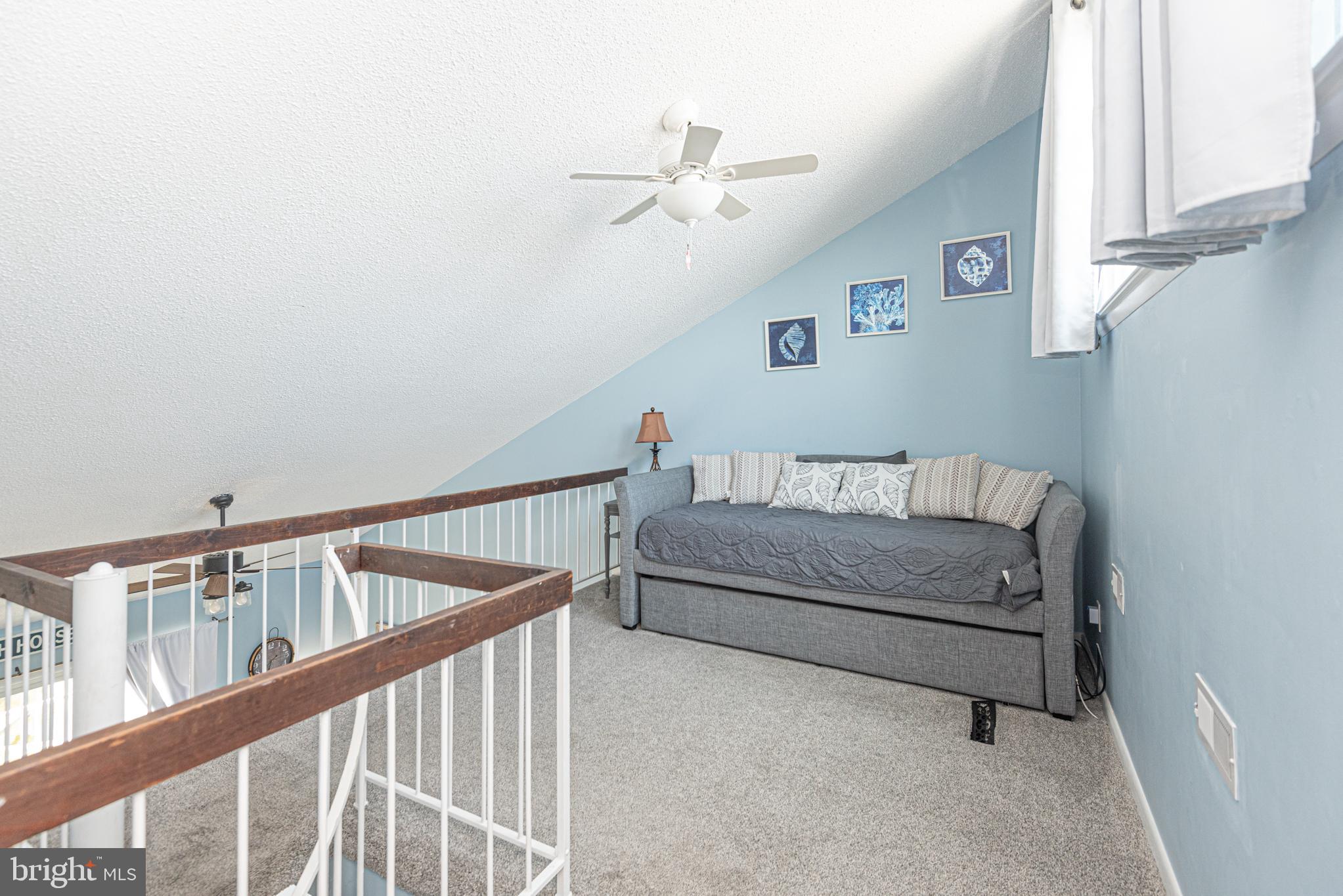 9203 Rusty Anchor Road, Unit A5 Ocean City, MD 21842 - Photo 42 of 60 a bedroom with furniture and a window