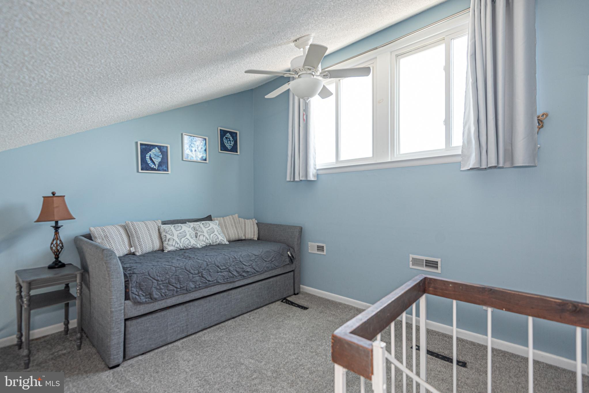 9203 Rusty Anchor Road, Unit A5 Ocean City, MD 21842 - Photo 43 of 60 a living room with furniture and a window