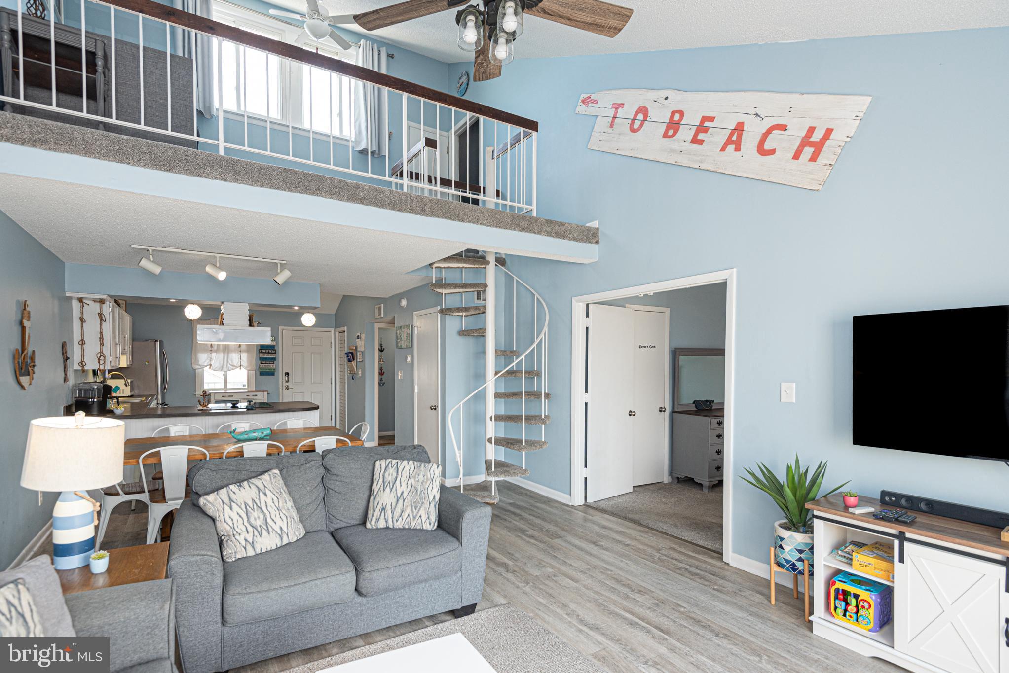 9203 Rusty Anchor Road, Unit A5 Ocean City, MD 21842 - Photo 49 of 60 a living room with furniture and a flat screen tv