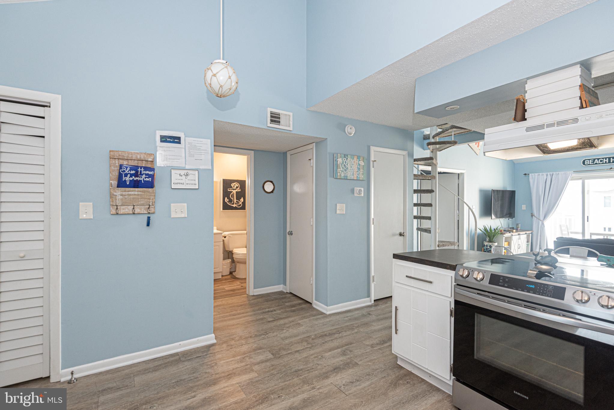 9203 Rusty Anchor Road, Unit A5 Ocean City, MD 21842 - Photo 51 of 60 a kitchen with stainless steel appliances granite countertop a refrigerator sink and stove