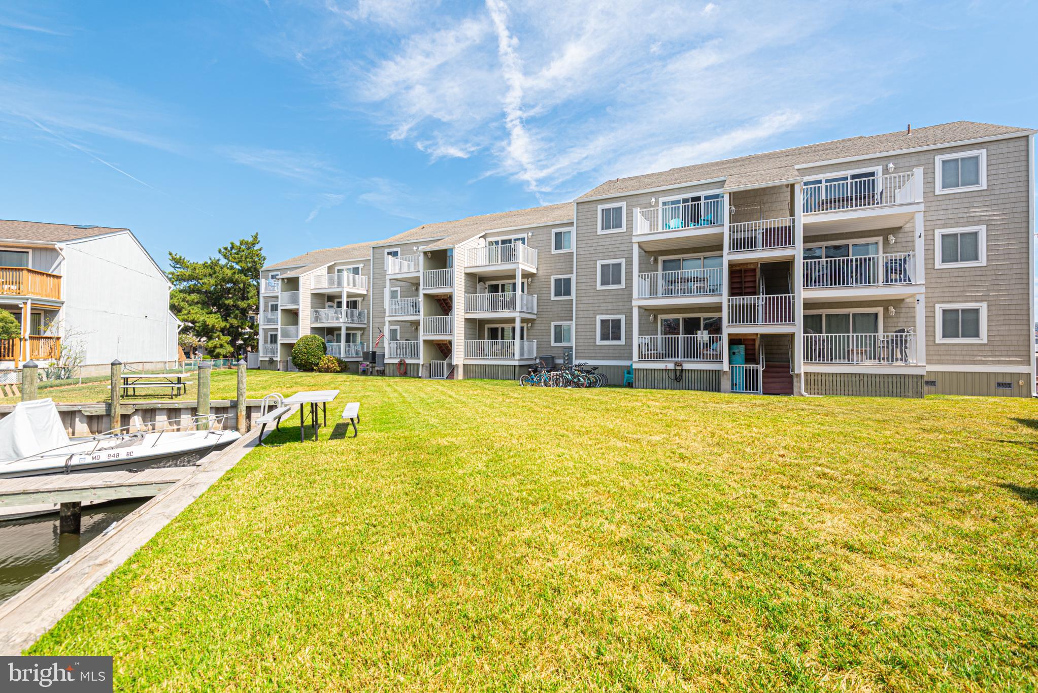 9203 Rusty Anchor Road, Unit A5 Ocean City, MD 21842 - Photo 52 of 60 a swimming pool with outdoor seating and yard