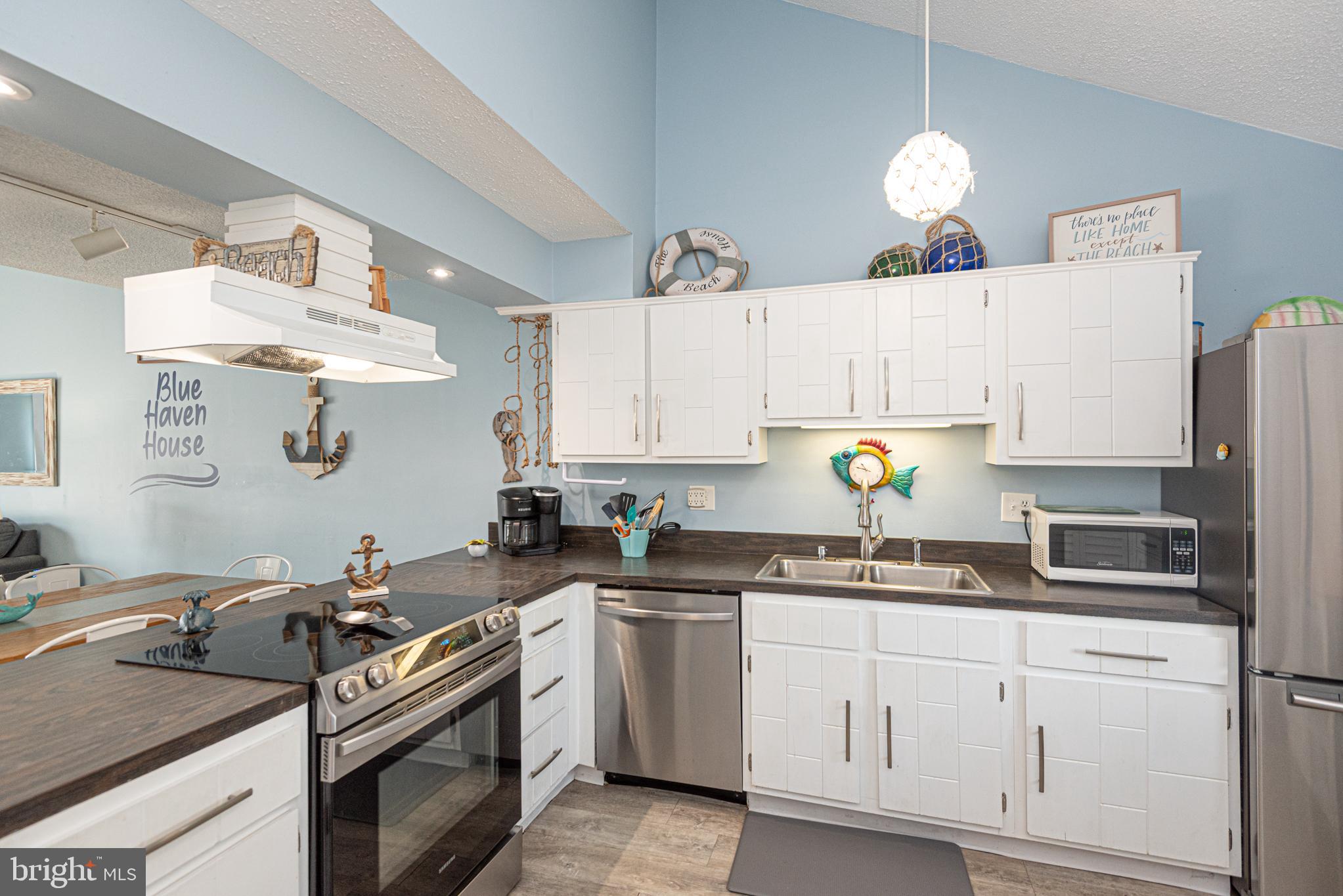 9203 Rusty Anchor Road, Unit A5 Ocean City, MD 21842 - Photo 8 of 60 a kitchen with cabinets a sink and appliances