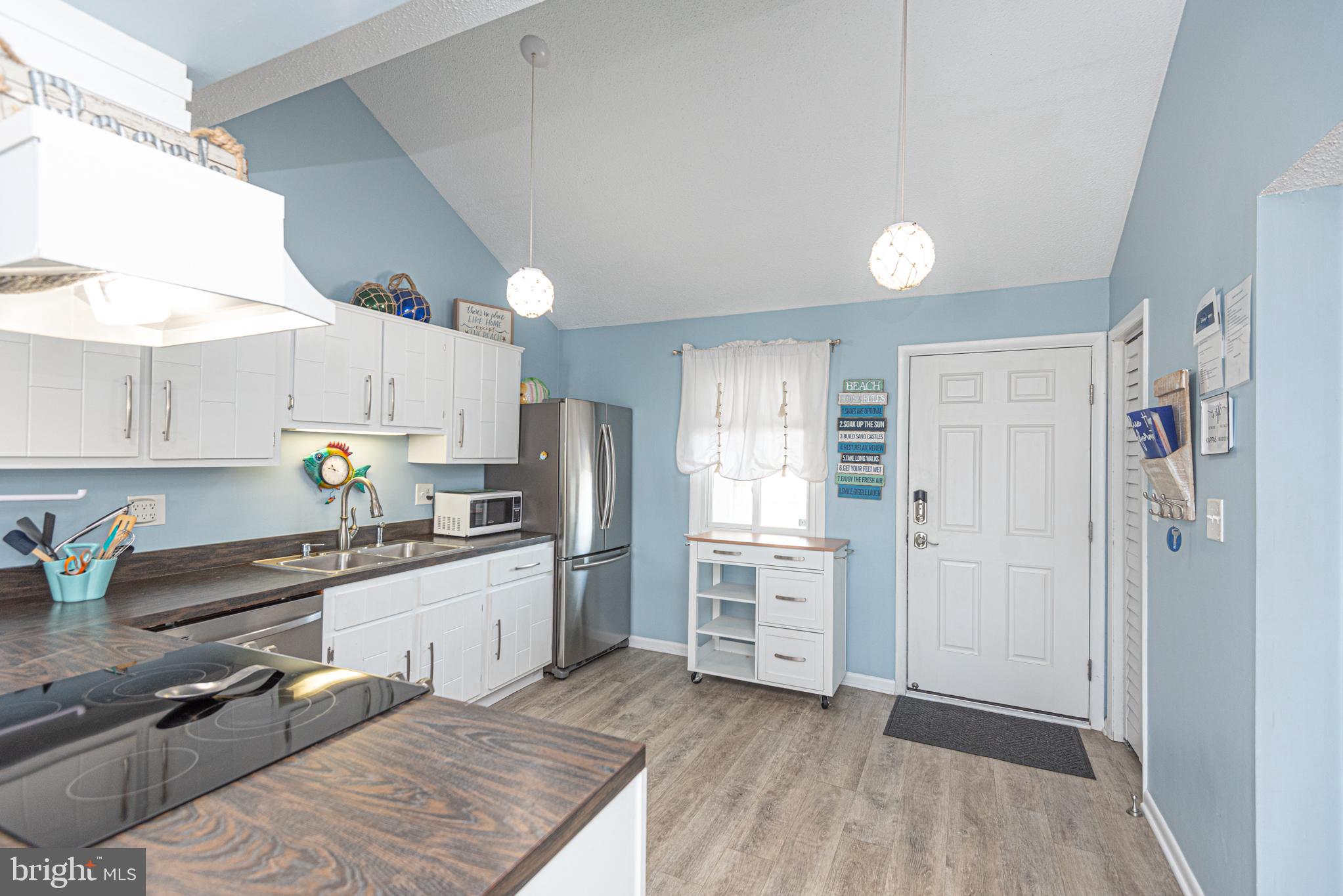9203 Rusty Anchor Road, Unit A5 Ocean City, MD 21842 - Photo 9 of 60 a kitchen with granite countertop a refrigerator stove and sink