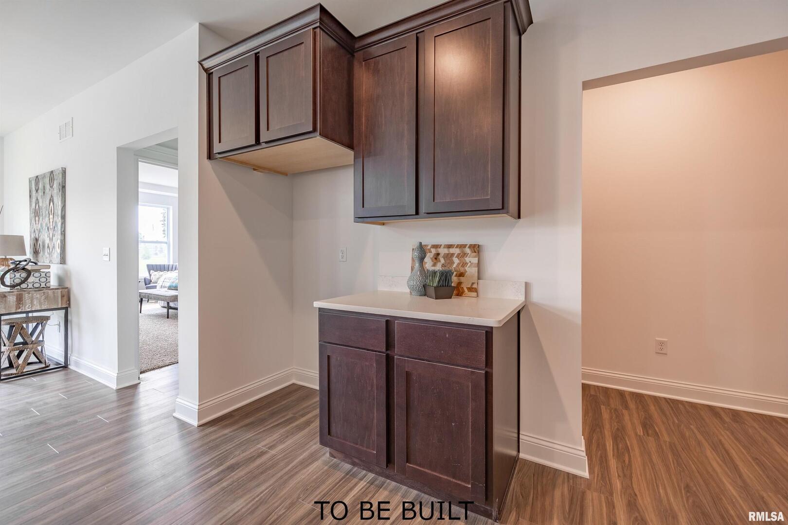 10 South 5th Street Eldridge, IA 52748 - Photo 13 of 29 a kitchen with a wooden floor and cabinets