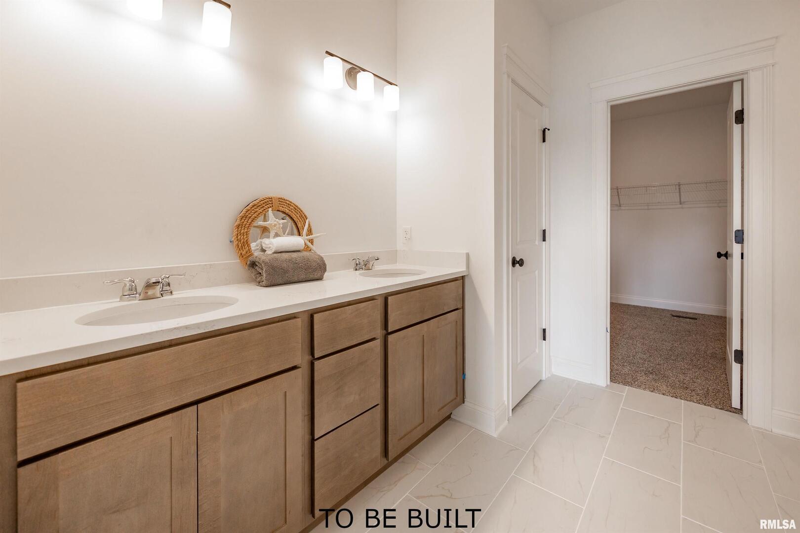 10 South 5th Street Eldridge, IA 52748 - Photo 17 of 29 a bathroom with a sink and a mirror
