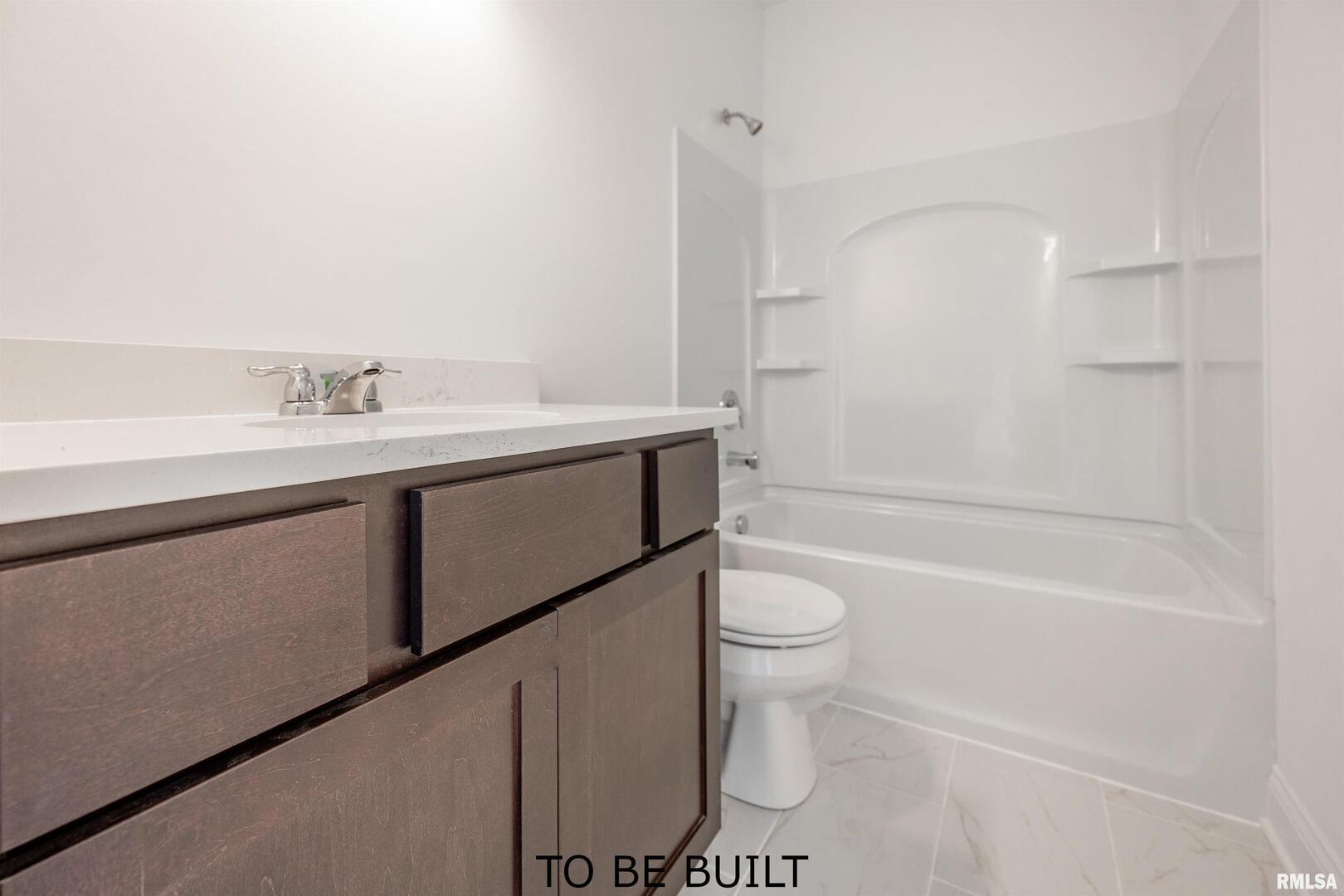 10 South 5th Street Eldridge, IA 52748 - Photo 24 of 29 a bathroom with a sink a toilet and a bathtub