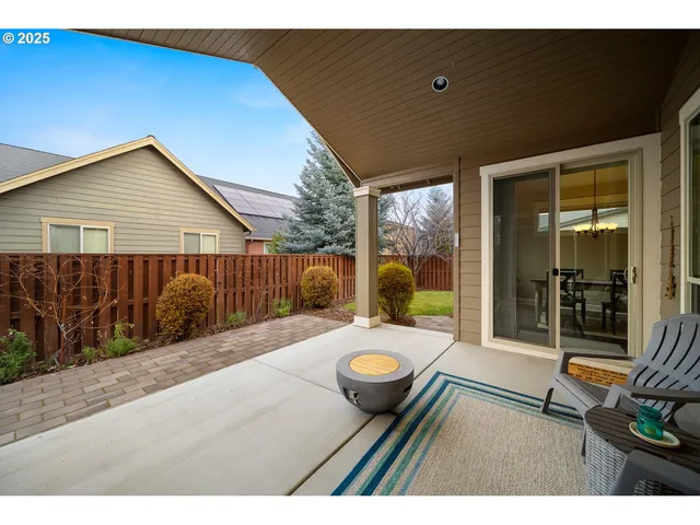 a view of a backyard with chair and table