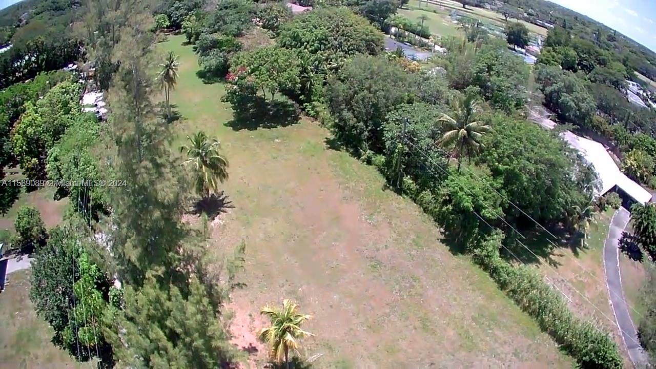 Vacant lot for sale. 1.59 acres of cleared and ready to build land with views of Killian Greens Golf course. Beautiful palms and fruit trees. Located in exclusive Killian area. Build you mansion here.