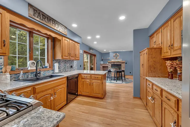 a kitchen with stainless steel appliances granite countertop sink stove top oven and cabinets