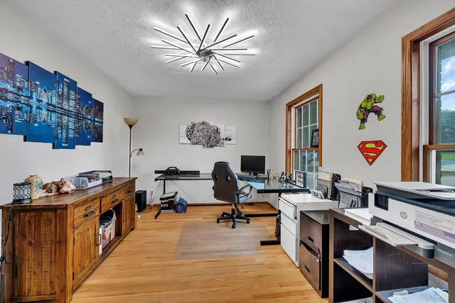 a very nice looking room with many windows and furniture