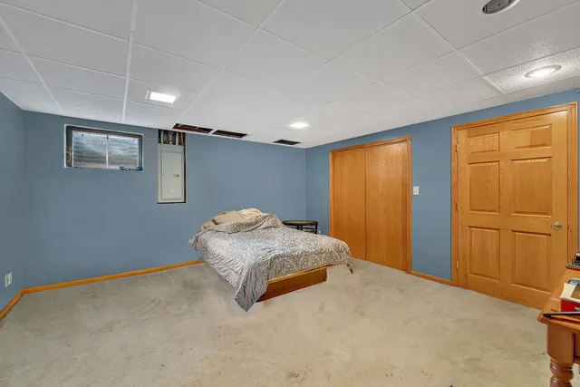 a bedroom with a bed and a painting on the wall