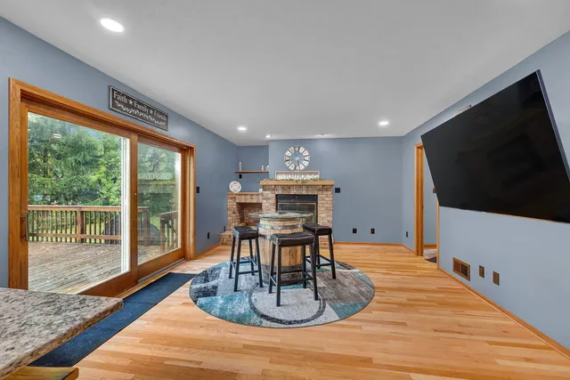 a dining room with furniture wooden floor and a rug