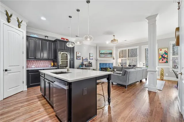a kitchen with a counter top space a sink appliances and cabinets