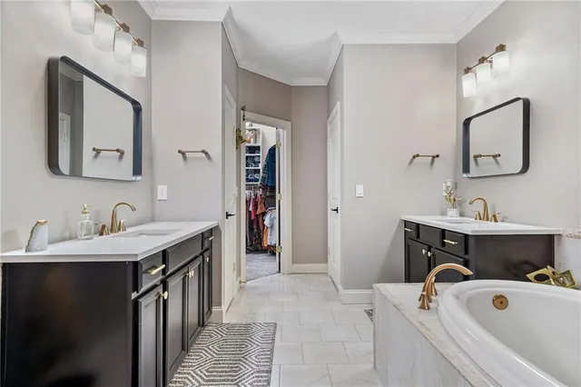 a bathroom with a tub sink and mirror