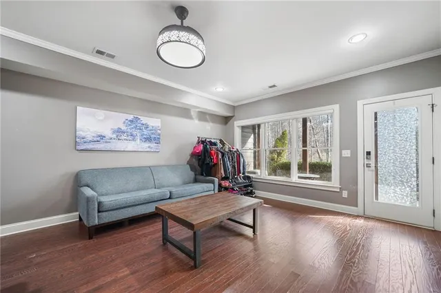 a living room with furniture and a floor to ceiling window