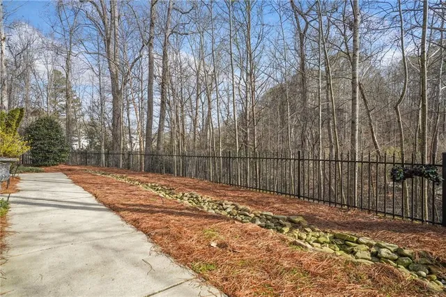 a view of backyard with wooden fence