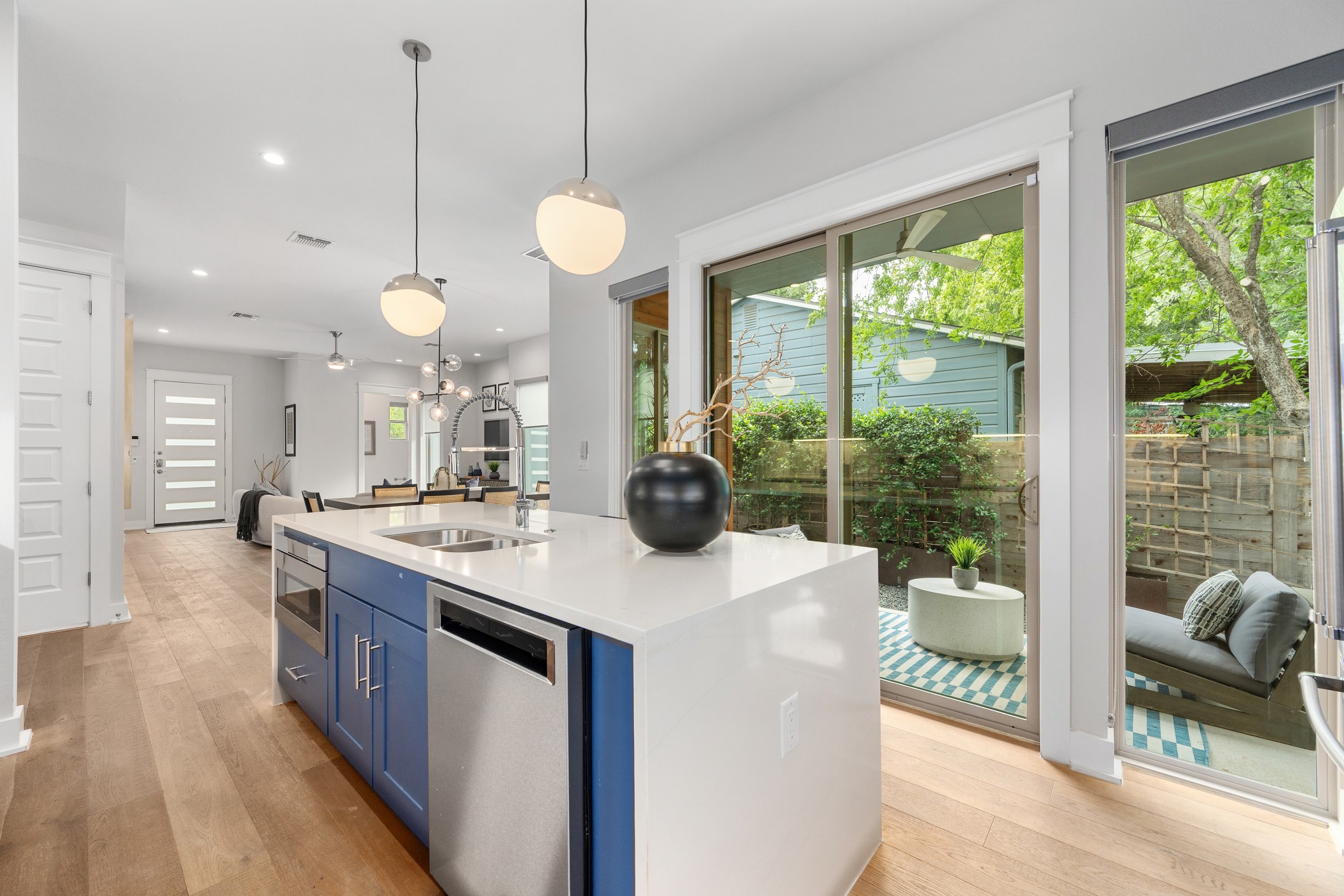 1409 Alegria Road, Unit A Austin, TX 78757 - Photo 9 of 24 A well-appointed kitchen boasts an island with a sink and a view of the private courtyard.