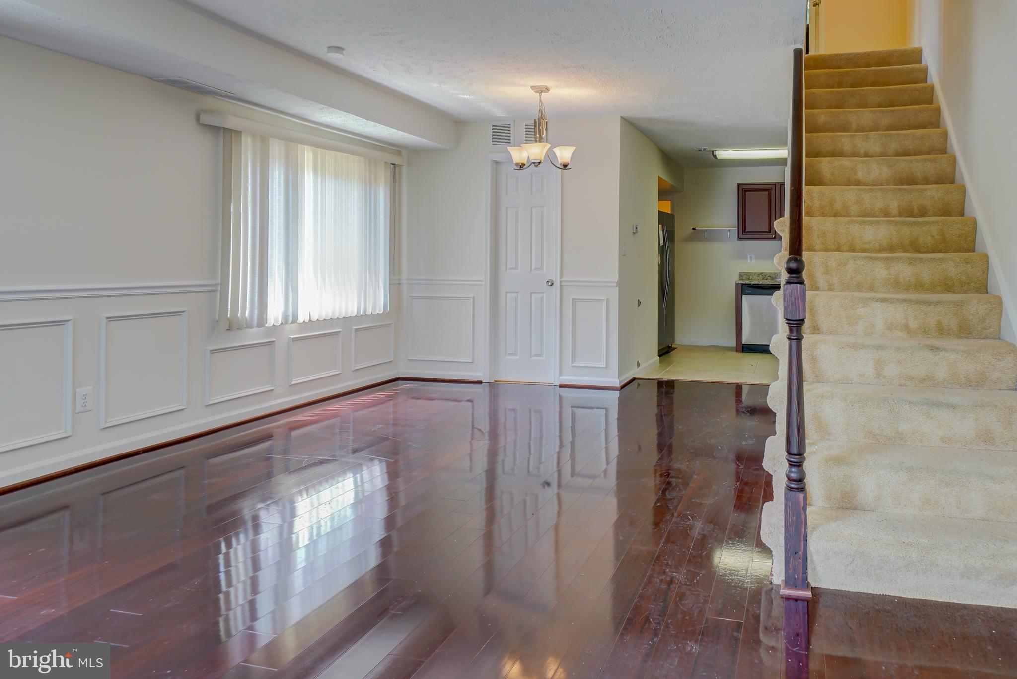 628 Four Mile Road Alexandria, VA 22305 - Photo 4 of 29 wooden floor in an empty room with a window