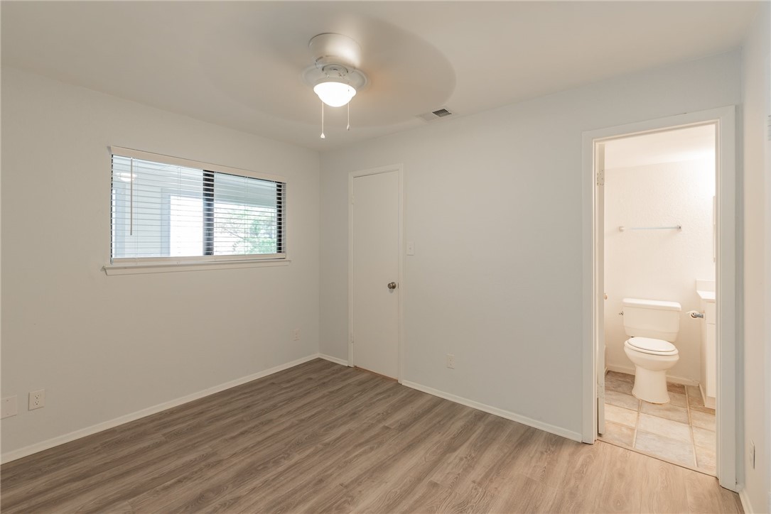 2500 Burleson Road, Unit 614 Austin, TX 78741 - Photo 14 of 20 a view of a room with wooden floor and a toilet