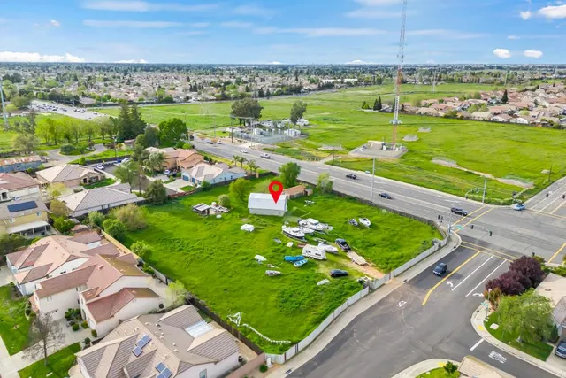 an aerial view of a residential houses with outdoor space and river